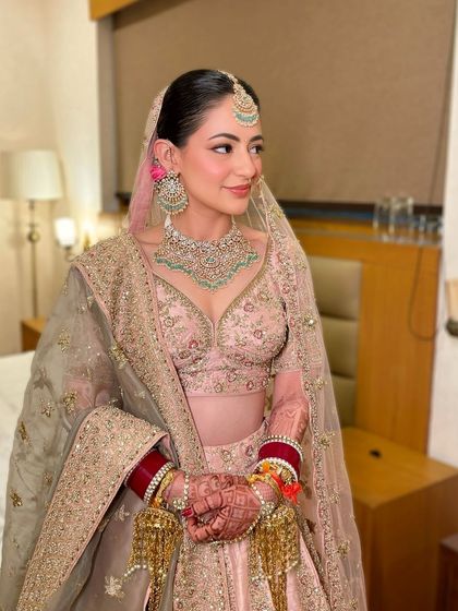 A full view of this stunning pastel bridal look. The makeup is soft and romantic, perfectly matching the vibe of the outfit.