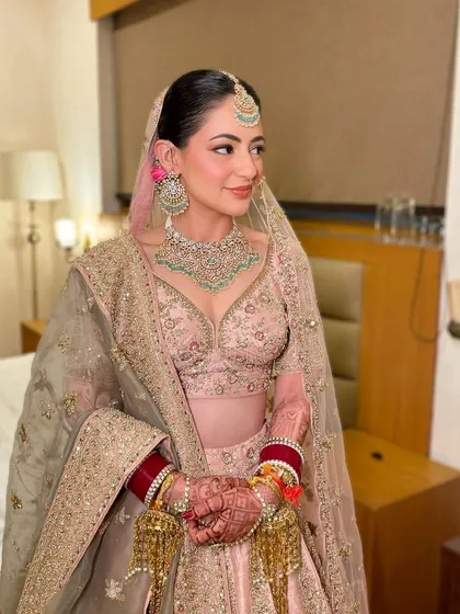 A full view of this stunning pastel bridal look. The makeup is soft and romantic, perfectly matching the vibe of the outfit.
