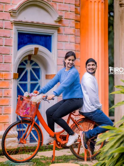 A fun and colorful shot with a bright orange bicycle against a European-style building facade.