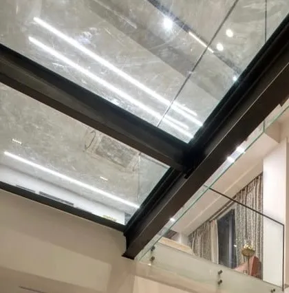A detail of the glass bridge and skylight in the Kedias Residence, which allows light to penetrate deep into the center of the house.