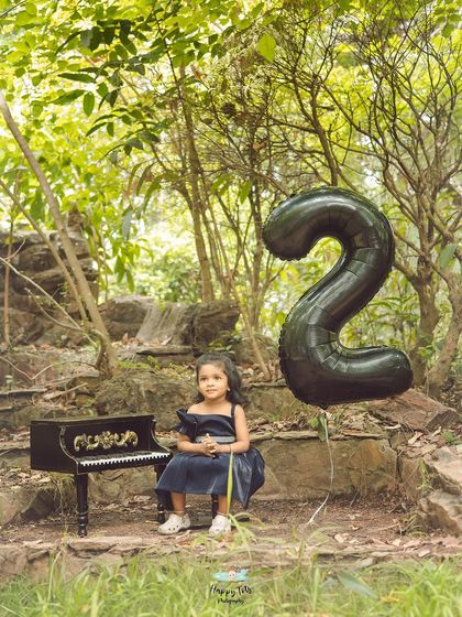 A duplicate of image 16, this shot captures the enchanting scene of a second birthday celebration set in a beautiful, rustic park.