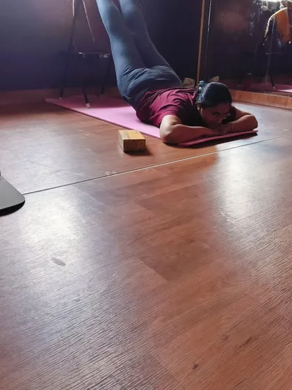 This image shows a restorative pose using a chair for a supported leg inversion. This is excellent for improving circulation and relieving tired legs and lower back tension.
