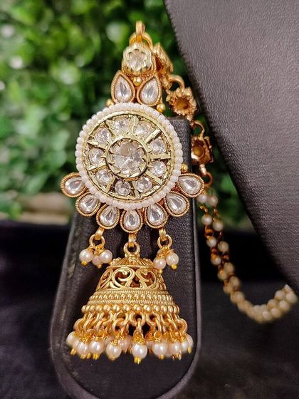 A detailed shot of a passa-style earring from my exclusive sale collection. The piece features a large polki stone surrounded by smaller stones and pearls.