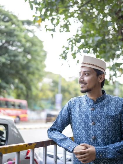 A portrait of the groom looking towards the future, with the bustle of the city in the background.