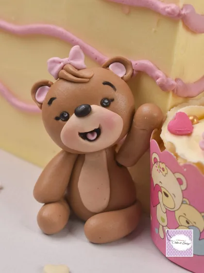 This sweet teddy bear figurine was part of a cake celebrating a baby's 3-month milestone. The design cleverly used cupcakes as a ladder to tell a story of growth.