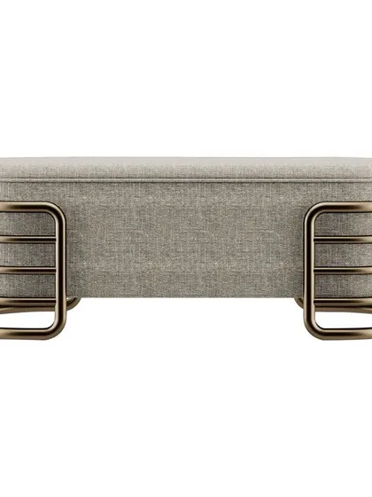 The Luna bench, featuring a fabric top and a unique base made of curved metal tubes. This piece is available in various finishes, including anodic bronze and glossy gold, to suit any interior.