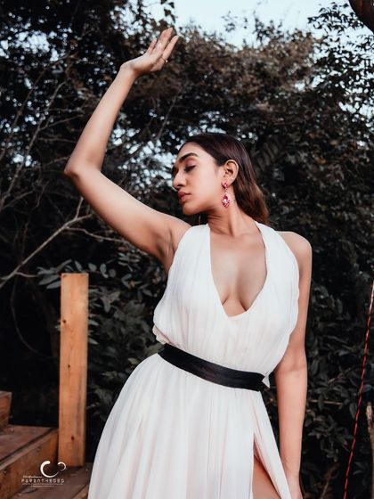 A graceful and expressive pose with an arm raised towards the sky. This portrait is full of hope, elegance, and natural beauty.