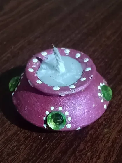 This is my modern take on the traditional diya. Each terracotta pot is hand-painted and filled with wax by me, perfect for celebrating a Green Diwali and bringing an authentic Indian feel to your festival decorations.