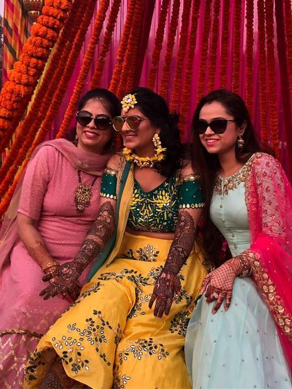 All smiles at a colorful Mehendi ceremony. I help my clients choose outfits like these vibrant lehengas that not only look great in photos but are also comfortable for celebrating all day long.