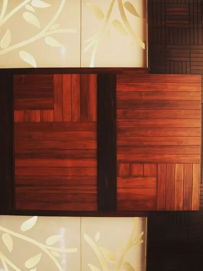 A creative wall panel at Overseas Traders combines reclaimed wood with a backlit Corian panel featuring a leaf motif.