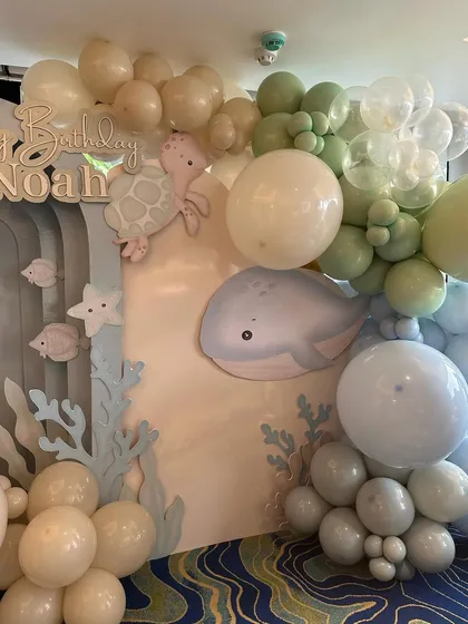 A close-up of the "Under the Sea" backdrop, showing the cute whale and turtle cutouts amidst the balloon bubbles.