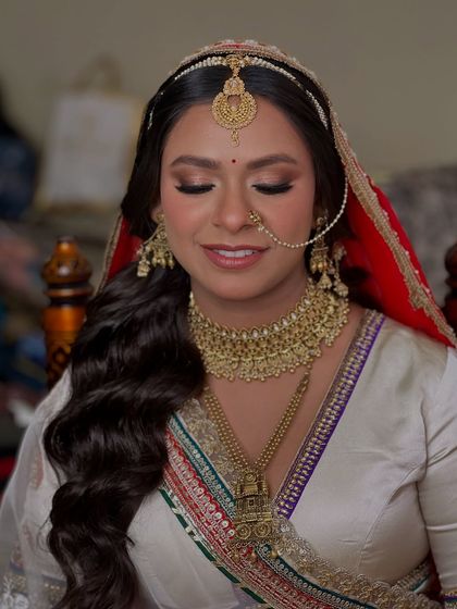 Eyes closed, you can appreciate the soft smokey eye and the perfectly groomed brows that frame her face.