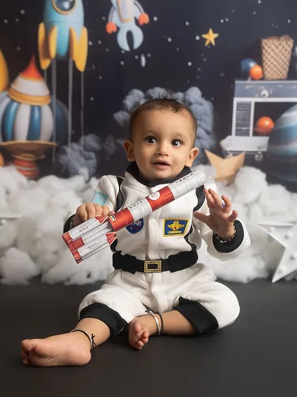 One small step for a baby, one giant leap for cuteness! This little astronaut is ready for his space mission in our out-of-this-world themed setup.