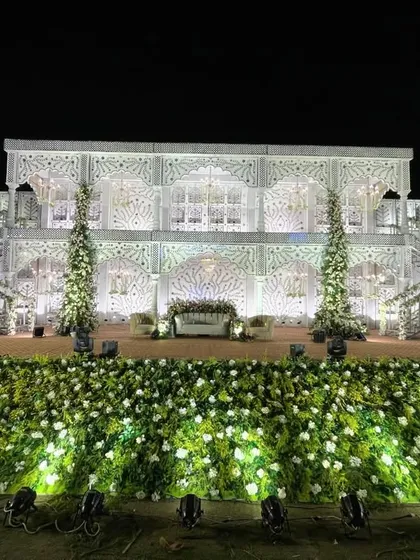 This is the kind of grandeur I love to create. A majestic, multi-level palace facade, intricately detailed and lit to perfection, serves as a breathtaking backdrop for a royal wedding reception.