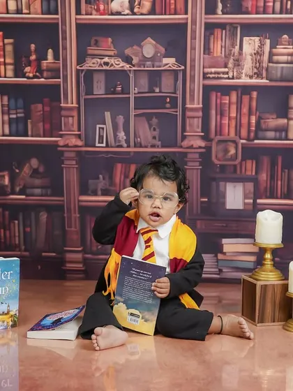 Deep in study, this little wizard is examining his book. The details, like the candle props, add to the magical ambiance.
