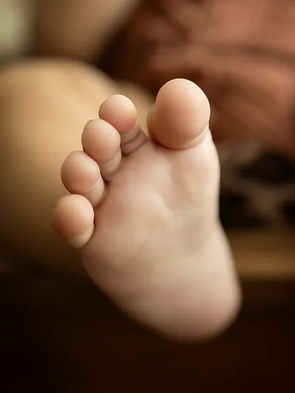 A close-up of a baby's perfect toes. These macro shots are a beautiful addition to any gallery, preserving the memory of their tiny features.