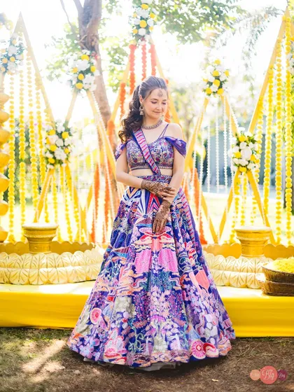 A beautiful portrait of the bride, Nelya, against the stunning yellow decor of her Haldi ceremony.