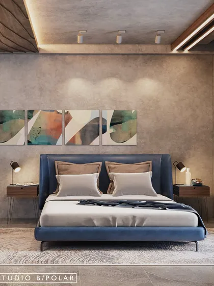 The guest bedroom is minimal and airy, with abstract art adding a splash of color above the deep blue bed. The concrete-finish walls and simple furniture create a contemporary, uncluttered feel.