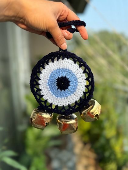 An evil eye ghungroo hanging, combining two powerful symbols of protection and positivity. A modern twist on a traditional decor item.