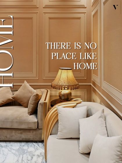 There is no place like a home designed with comfort in mind. This image captures a cozy corner with classic wall molding, plush sofas, and warm lighting, embodying a timeless sense of home.