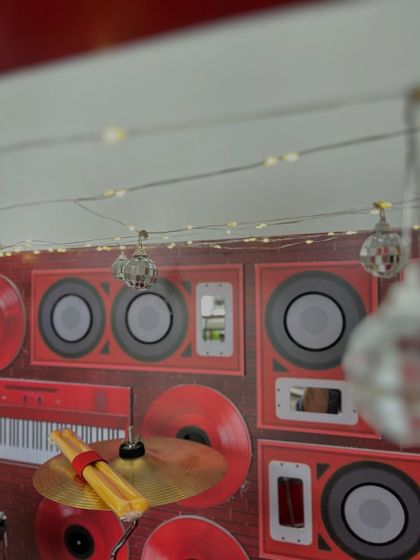 A close-up of the tiny disco balls and speaker backdrop from the garage band hamper.