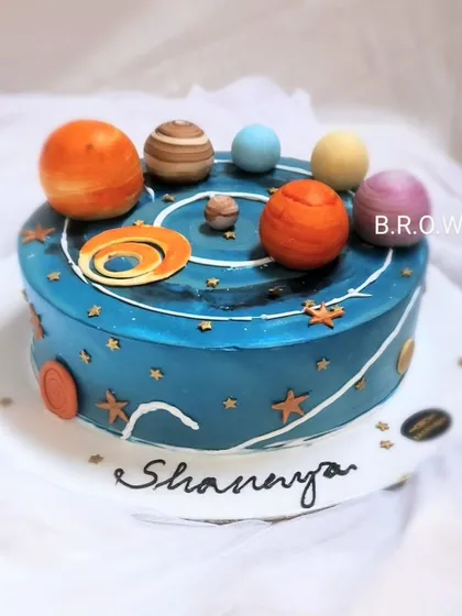 This is more than just a cake; it's a piece of art. We created this space-themed chocolate truffle cake with detailed, edible planets and a galaxy design for a truly out-of-this-world celebration.