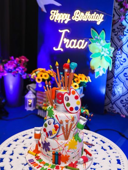 An incredible art-themed birthday cake, shaped like a painter's palette and brushes, perfectly matching the creative celebration.