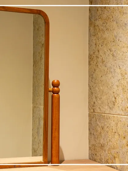 A close-up of the custom-designed wooden mirror in the ladies' washroom. The turned wood detail adds a handcrafted, colonial-era touch that elevates the entire space.