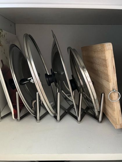A lid organizer is one of the best investments for an organized kitchen. This simple rack keeps pot lids and chopping boards stored vertically, saving valuable cabinet space and making them easy to find.