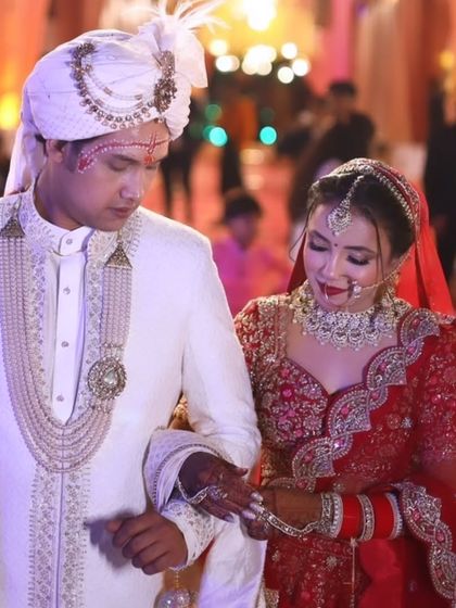 The bride and groom walking together. The makeup is designed to complement the groom's attire and the overall wedding aesthetic.