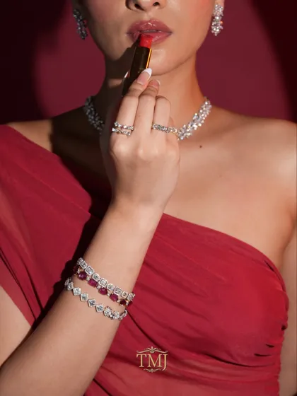 In ancient Sanskrit texts, rubies represented the sun and diamonds the stars. Together, they meant cosmic balance. Here, a model applies lipstick while wearing the set.