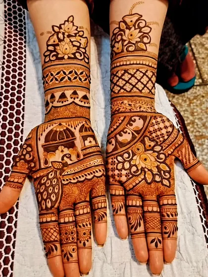 A lovely fusion design with dome architecture on the palms and floral cuffs, combining different styles in one cohesive piece.