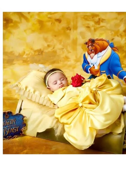 A tale as old as time. For this newborn photoshoot, we created a beautiful Belle-inspired gown in golden yellow satin with a large bow, perfect for the sleeping beauty.