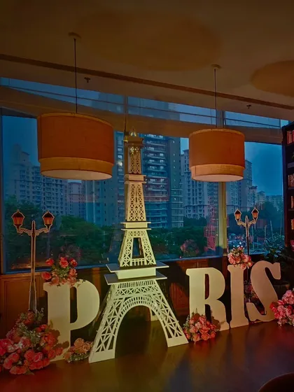 A beautiful shot of the Paris-themed decor at The Quorum Club, showing the Eiffel Tower against the backdrop of the city lights.