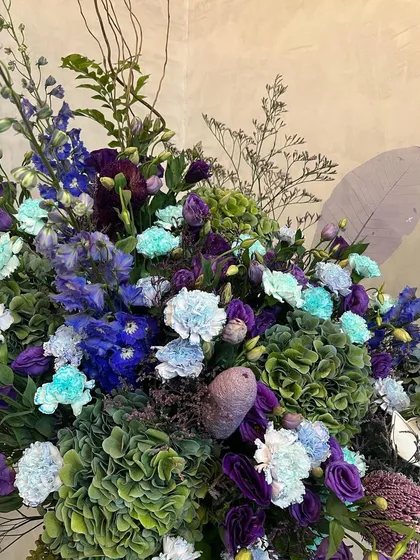 A close-up of my sea green and deep purple arrangement. The juxtaposition of the cool-toned carnations against the rich purple and green hydrangeas creates a chic and harmonious look.