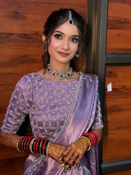 A soft and pretty look for an engagement or pre-wedding function. The lavender saree is complemented by a makeup look with purple and pink undertones and a simple, elegant hairstyle.