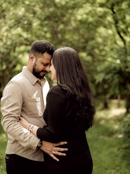 An intimate moment of the couple touching foreheads in a quiet forest setting. It’s a beautiful, peaceful portrait of their unity.