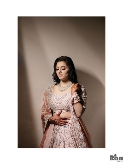 A simple and elegant portrait of the bride, looking down with a gentle smile. The soft lighting creates a serene and graceful mood.