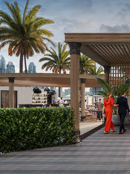 A 3D rendering of the outdoor lounge at the Fairmont Hotel in the Middle East. This image captures the lifestyle aspect of the property, showing how guests interact with the space, with careful attention to the natural lighting, tropical landscaping, and distant city views.