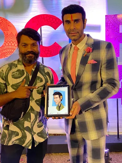 Here I am with Sandip Soparrkar and the finished digital caricature I drew for him at the literature festival.