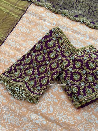 The sleeves of the purple blouse, showing the dense embroidery.