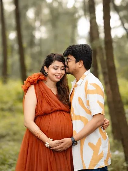 So much love and anticipation in one photo. This couple's forest photoshoot is a perfect example of a romantic and natural setting, enhanced by the warm color of the maternity rental gown.