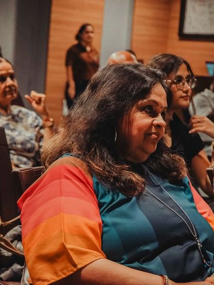 A close-up of an audience member, capturing her thoughtful expression during a performance.