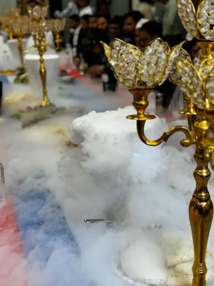 A close-up of the crystal candelabra, a key element of our premium table decor, surrounded by the magical dry ice smoke.