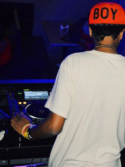 A view from behind the console during a club night. This perspective shows my Pioneer setup and the typical low light, high energy environment of a nightlife DJ gig.