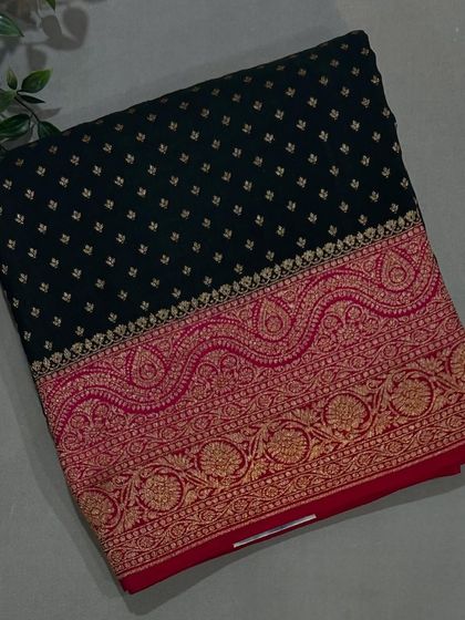 A stunning black Banarasi crepe saree with a contrasting red and gold woven border.