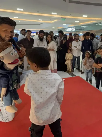 Another interactive moment with a young boy from the crowd during a mall show.