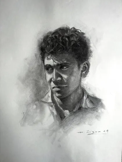 This charcoal portrait captures a moment of quiet contemplation. The strong contrast between the dark, shaded background and the brightly lit side of his face creates a dramatic, focused effect.