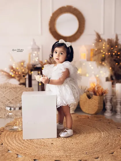 A little explorer! This shot captures the new mobility and curiosity of a one-year-old during her birthday photoshoot.