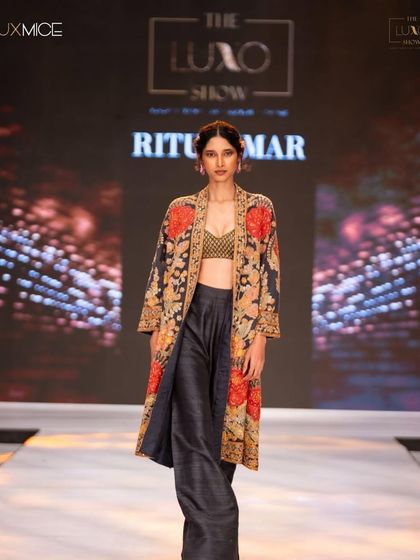 A classic runway look for Ritu Kumar at The Luxo Show. The makeup is clean and fresh, with a simple updo to let the beautifully embroidered jacket take center stage.